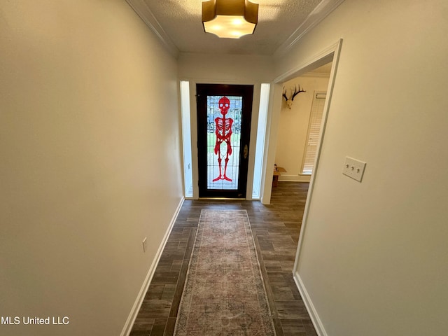 doorway to outside featuring ornamental molding, a textured ceiling, and dark hardwood / wood-style flooring