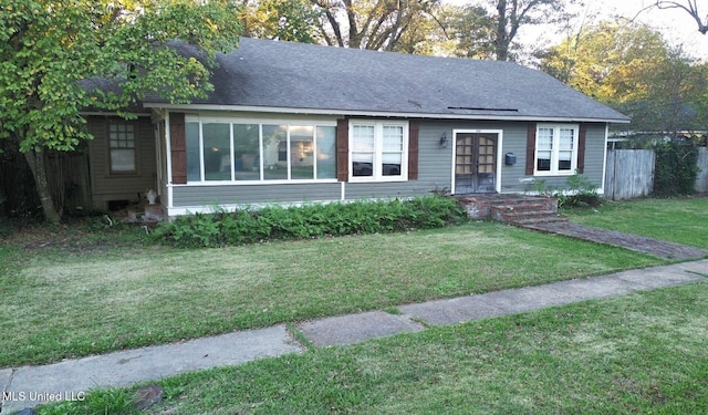 single story home with a front lawn