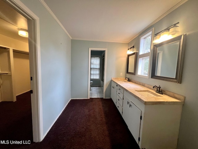 bathroom featuring vanity, crown molding, and toilet