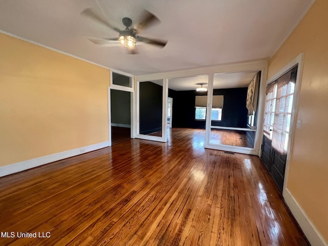 unfurnished room featuring wood-type flooring, crown molding, and ceiling fan