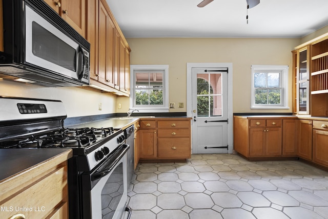 kitchen with ceiling fan, stainless steel appliances, a sink, brown cabinets, and open shelves