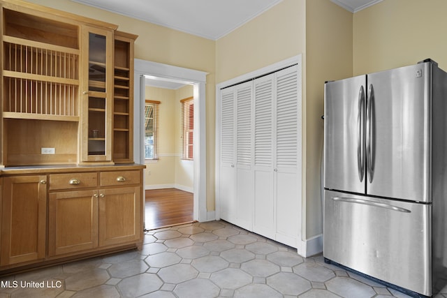 kitchen with baseboards, ornamental molding, freestanding refrigerator, open shelves, and brown cabinetry