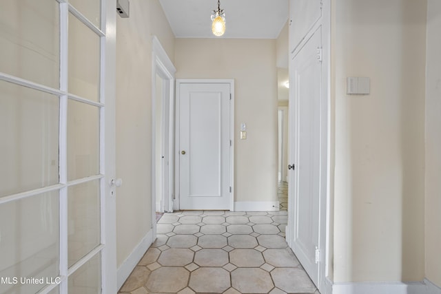 hallway featuring baseboards