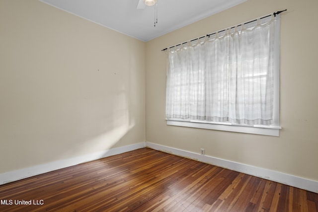 spare room featuring ceiling fan, hardwood / wood-style floors, and baseboards