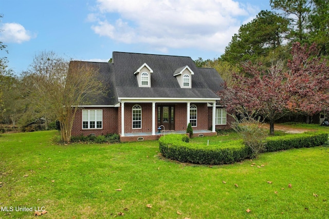 cape cod house with covered porch and a front yard