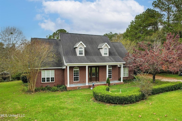 cape cod house featuring a front yard and a porch