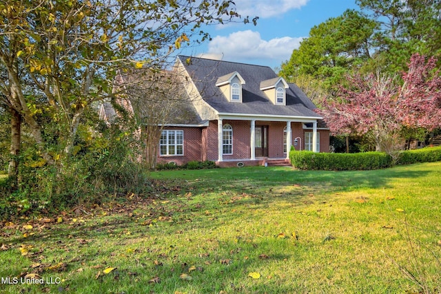 cape cod house with a front lawn