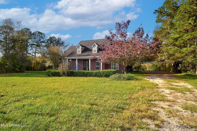 cape cod home featuring a front yard