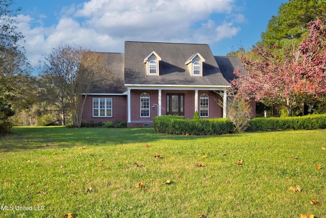 cape cod house featuring a front lawn