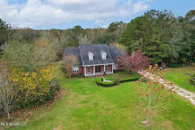 cape cod house featuring a porch and a front lawn