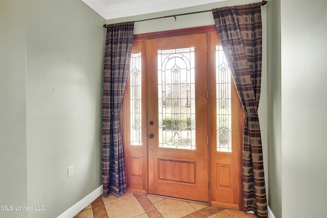 foyer featuring light tile patterned floors, ornamental molding, and a wealth of natural light