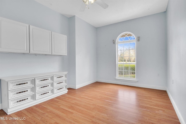 empty room featuring ceiling fan and light wood-type flooring