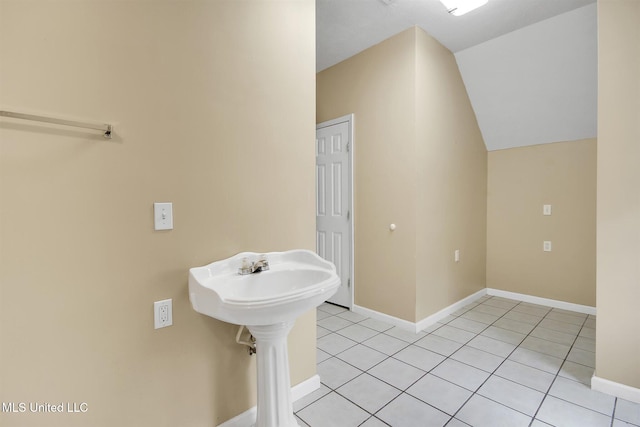 bathroom with tile patterned flooring and vaulted ceiling