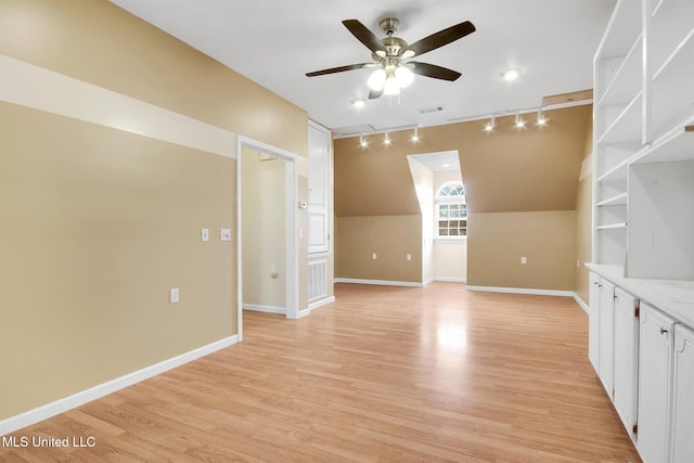 unfurnished living room with ceiling fan, track lighting, light hardwood / wood-style floors, and lofted ceiling