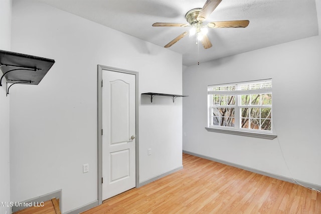 unfurnished bedroom with ceiling fan and light hardwood / wood-style floors