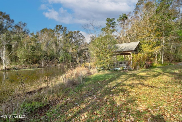 view of yard featuring a gazebo and a water view