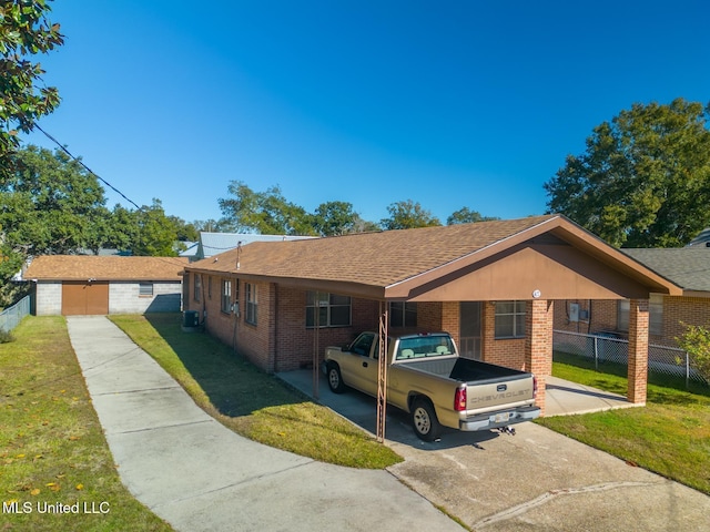 ranch-style house with a front yard, central AC, and a carport