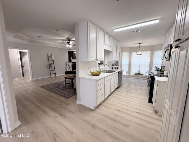 106 Ole Duke Dr, Brandon, MS 39042 - kitchen with stainless steel appliances, a sink, light countertops, white cabinets, and light wood-style flooring