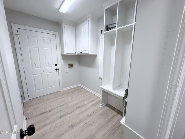 106 Ole Duke Dr, Brandon, MS 39042 - laundry room featuring hookup for a washing machine, light wood-style flooring, baseboards, and cabinet space