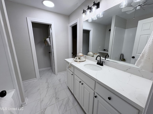 106 Ole Duke Dr, Brandon, MS 39042 - full bathroom featuring marble look tile flooring, vanity, baseboards, and ceiling fan