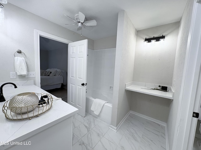 106 Ole Duke Dr, Brandon, MS 39042 - ensuite bathroom featuring ceiling fan, vanity, tub / shower combination, baseboards, and marble finish floors