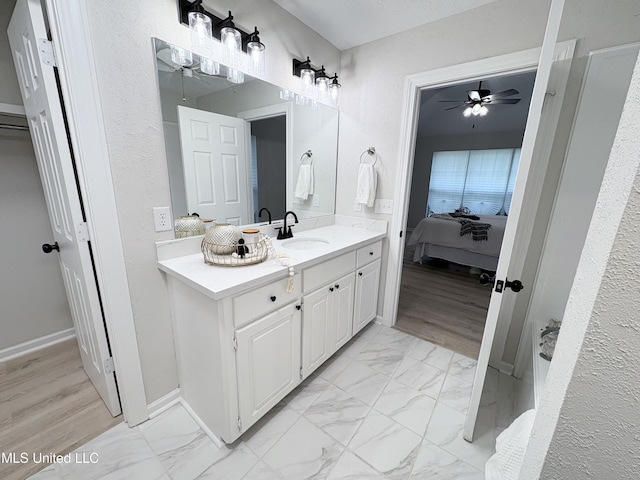 106 Ole Duke Dr, Brandon, MS 39042 - ensuite bathroom with ceiling fan, vanity, and marble look tile flooring