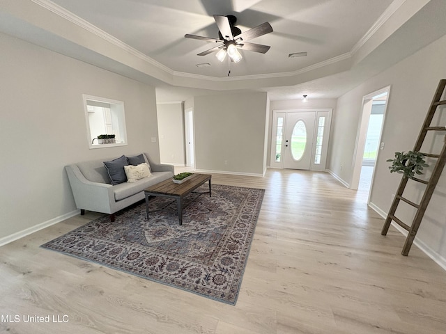 106 Ole Duke Dr, Brandon, MS 39042 - living area featuring ornamental molding, ceiling fan, baseboards, light wood-style floors, and a tray ceiling