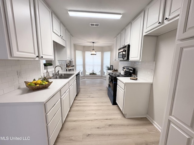 106 Ole Duke Dr, Brandon, MS 39042 - kitchen with appliances with stainless steel finishes, a sink, light wood-type flooring, and light countertops