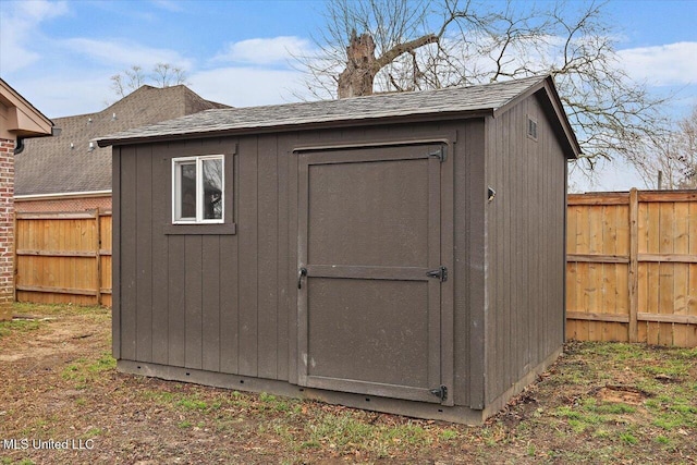 view of shed featuring fence