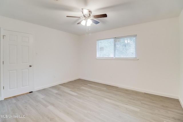 empty room featuring light wood finished floors, ceiling fan, and baseboards