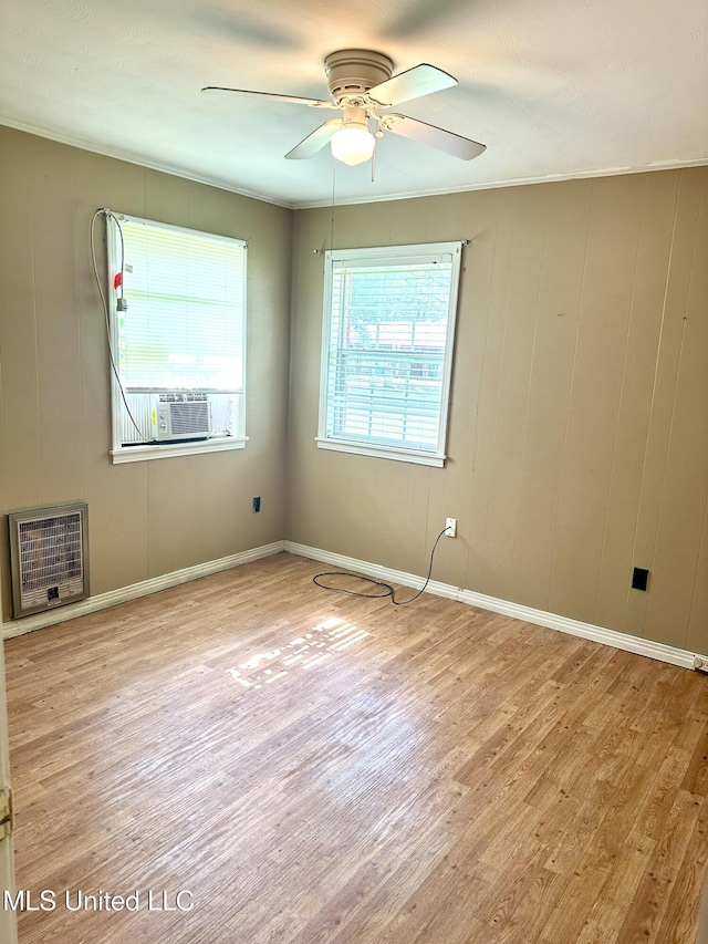 176 Revell Rd, Grenada, MS 38901 - unfurnished room with wood finished floors, ceiling fan, heating unit, and baseboards