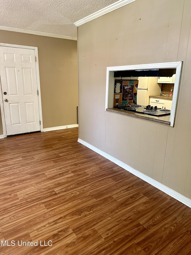 176 Revell Rd, Grenada, MS 38901 - empty room featuring wood finished floors, crown molding, a textured ceiling, and baseboards