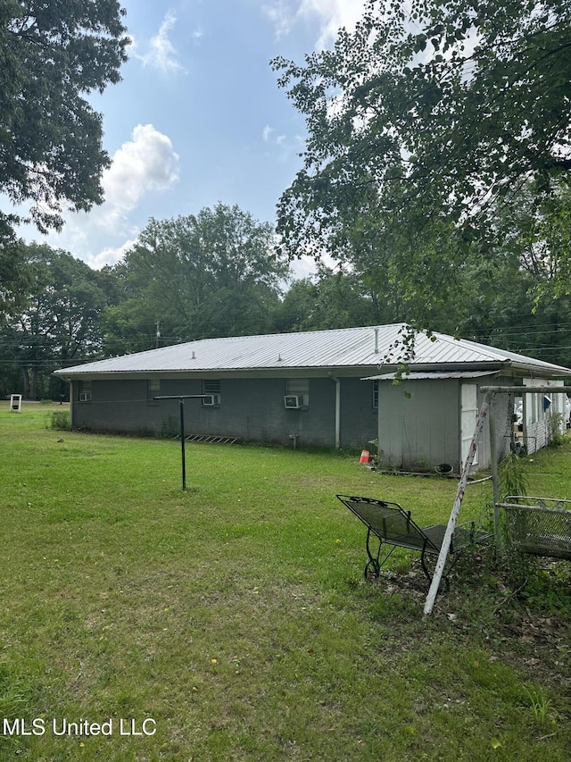 176 Revell Rd, Grenada, MS 38901 - rear view of house with a lawn and metal roof