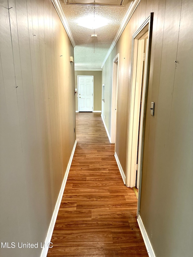 176 Revell Rd, Grenada, MS 38901 - hall with wood finished floors, ornamental molding, attic access, wood walls, and baseboards