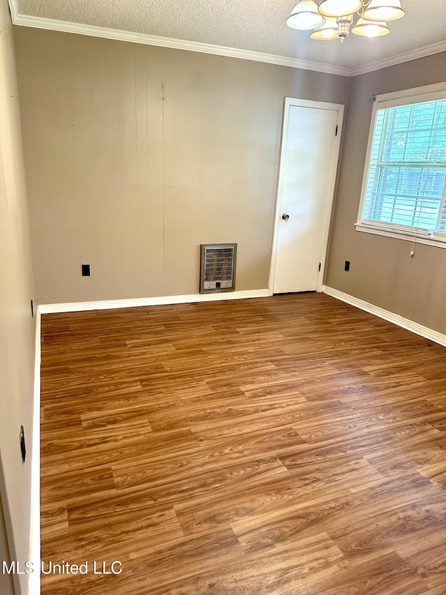 176 Revell Rd, Grenada, MS 38901 - unfurnished room featuring heating unit, wood finished floors, baseboards, a chandelier, and ornamental molding