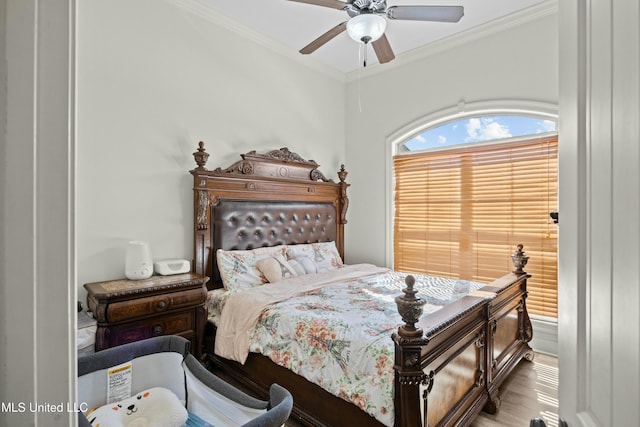 bedroom featuring a ceiling fan, crown molding, and light wood finished floors