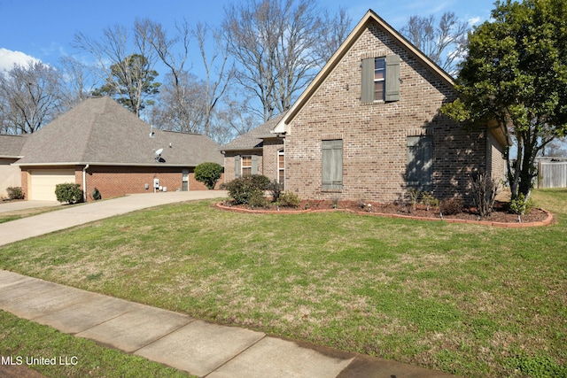 view of front of property featuring a front yard, concrete driveway, and brick siding