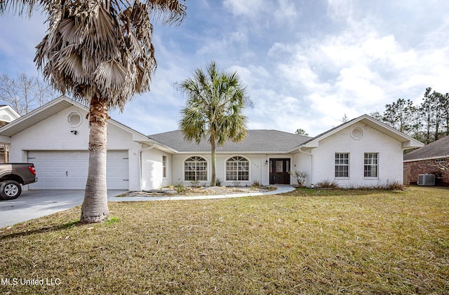 view of front of property featuring an attached garage, driveway, a front yard, and brick siding