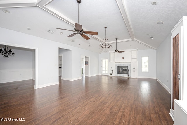 unfurnished living room with dark wood-style floors, vaulted ceiling with beams, visible vents, a ceiling fan, and a glass covered fireplace