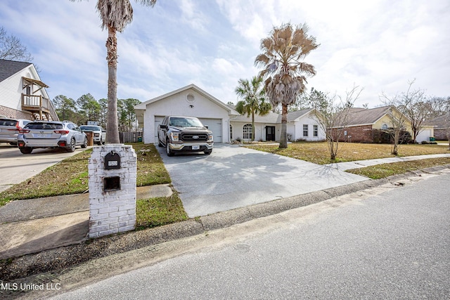 view of front of home featuring an attached garage, a residential view, and concrete driveway