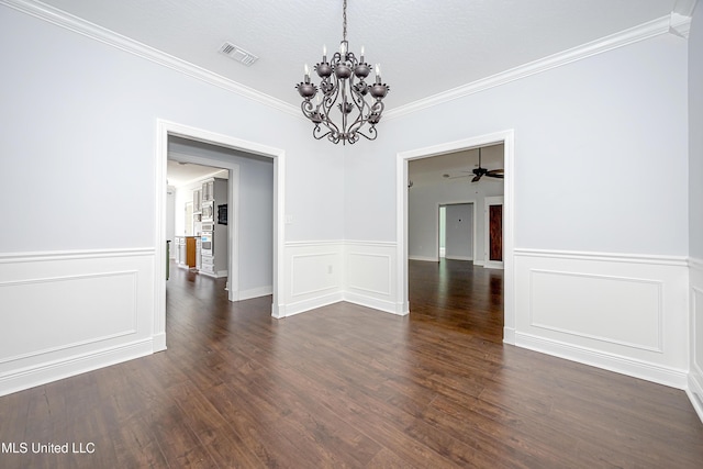 unfurnished dining area featuring a chandelier, a decorative wall, visible vents, dark wood-style floors, and crown molding