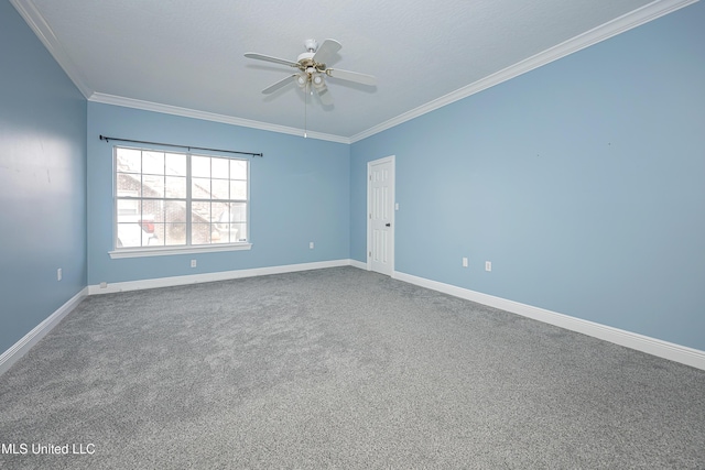 carpeted spare room featuring ornamental molding, ceiling fan, and baseboards