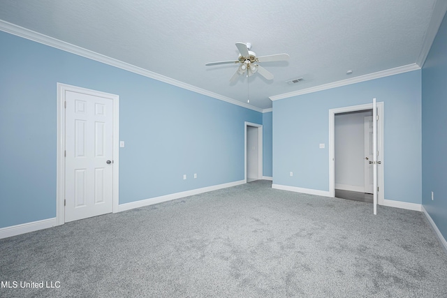 unfurnished room featuring carpet floors, visible vents, ornamental molding, ceiling fan, and a textured ceiling