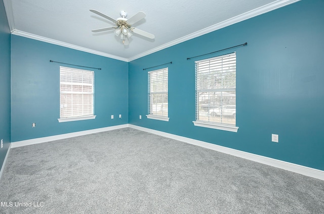 empty room with ceiling fan, ornamental molding, and baseboards