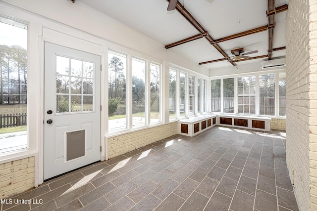 unfurnished sunroom with a ceiling fan and a healthy amount of sunlight