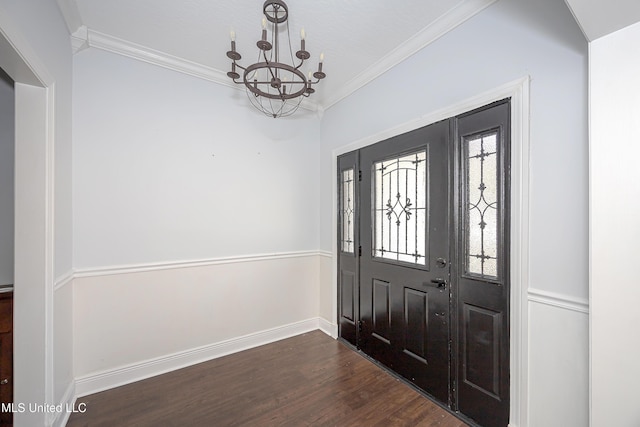 entrance foyer featuring dark wood-style floors, a chandelier, crown molding, and baseboards