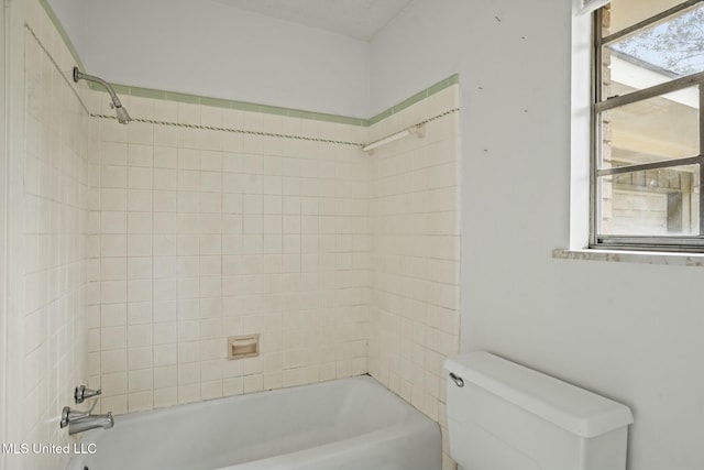 bathroom featuring shower / bath combination and toilet