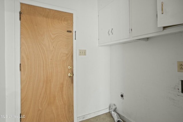 laundry area featuring cabinet space, baseboards, and electric dryer hookup