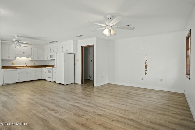 kitchen featuring white cabinetry, white appliances, light wood-style flooring, and visible vents