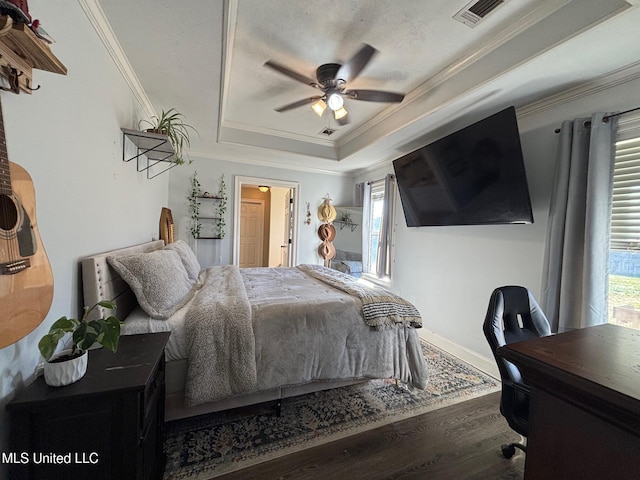 bedroom with hardwood / wood-style flooring, ceiling fan, ornamental molding, and multiple windows